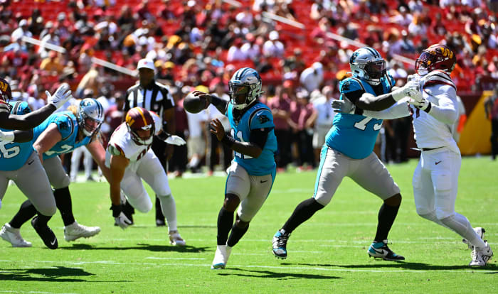 Aug 13, 2022; Landover, Maryland, USA; Carolina Panthers quarterback PJ Walker (11) scrambles against the Washington Commanders during the second half at FedExField. Mandatory Credit: Brad Mills-USA TODAY Sports